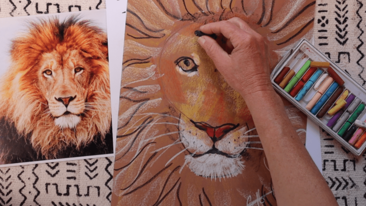 Artist drawing a realistic lion portrait with pastels.