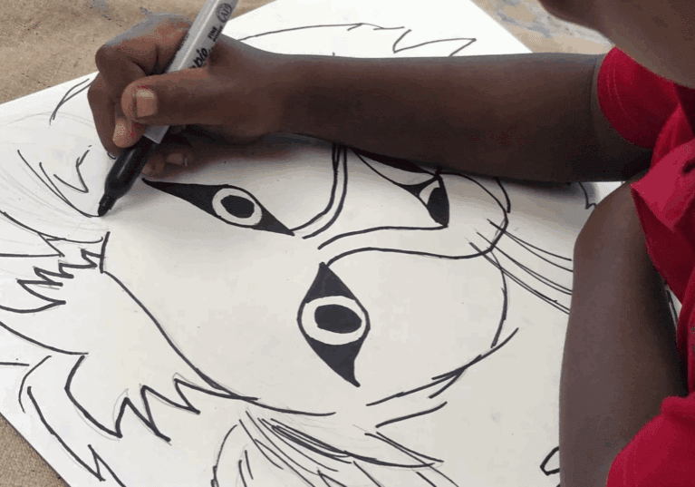 Person sketching a cartoon character face.